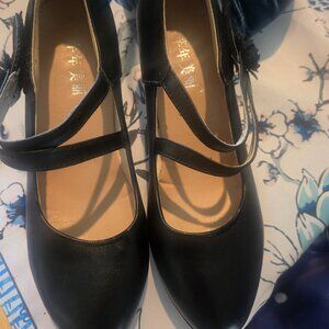Black Mary Jane heals. Never worn. Size 8. Hook and loop strap adjusts to sizes